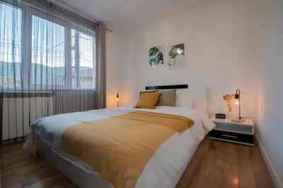 a bedroom with a large bed and a large window at Hyggemate - 1 Bed Room Cozy Apartment in Sarnitsa in Sarnitsa