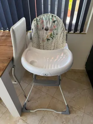 a white high chair sitting next to a window at Apartment near Vitosha mountain, self check-in, with underground parking in Sofia