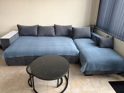 a living room with a couch and a table at Apartment near Vitosha mountain, self check-in, with underground parking in Sofia