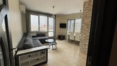 a living room with a couch and a table at Apartment near Vitosha mountain, self check-in, with underground parking in Sofia