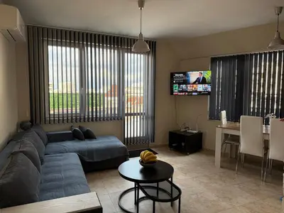 a living room with a blue couch and a tv at Apartment near Vitosha mountain, self check-in, with underground parking in Sofia