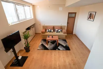 a living room with a couch and a table at Studio KFC in Sofia