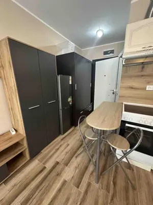 a small kitchen with a table and chairs in a room at Mirror Residenced & private parking in Sofia
