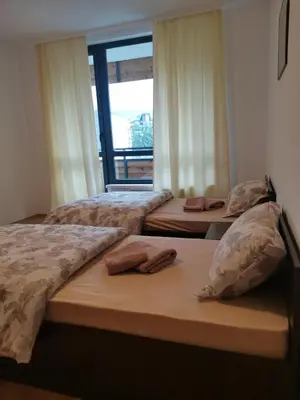 three beds in a room with a window at Pirin Views Aspen A337 in Razlog