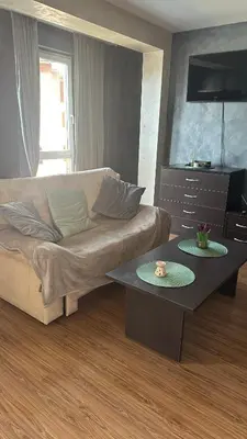 a living room with a couch and a table at Eleonor Mountain Studio in Bansko