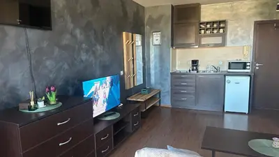 a kitchen with a tv on top of a dresser at Eleonor Mountain Studio in Bansko