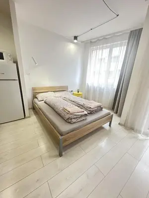 a bedroom with a bed and a refrigerator at Urban Nest 7 studio in Sofia