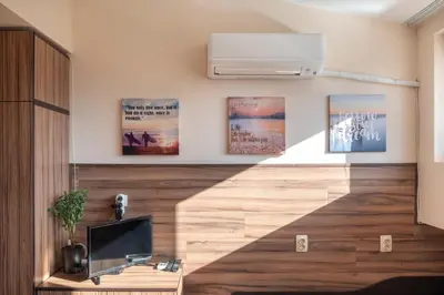 a living room with a desk and a heater on the wall at Studio Subway in Sofia