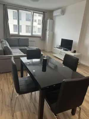 a living room with a table and a couch at Metropolitan Paradise & private parking in Sofia
