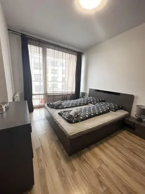 a bedroom with a bed and a large window at Metropolitan Paradise & private parking in Sofia