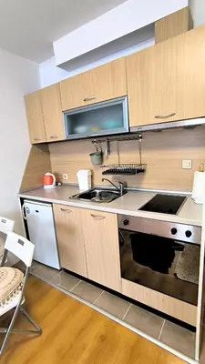 a kitchen with a sink and a stove top oven at Cozy SPA Retreat with free Bottle of Wine in Aspen Golf in Razlog