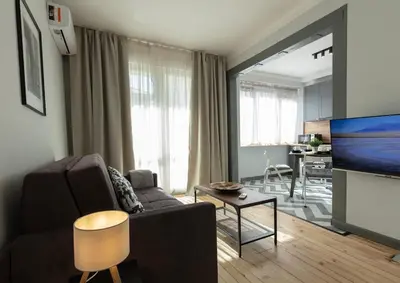 a living room with a couch and a flat screen tv at Downtown Stylish Flat in Sofia