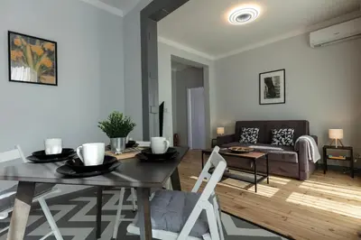 a living room with a table and a couch at Downtown Stylish Flat in Sofia