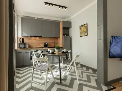 a kitchen with a table and chairs in a room at Downtown Stylish Flat in Sofia