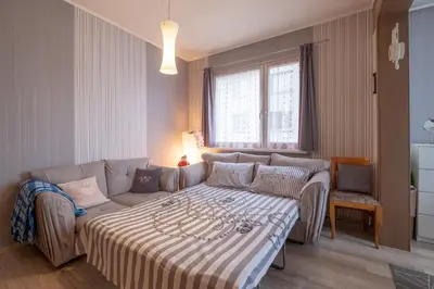 a living room with a bed and a couch at Little HoMe with a Park View by Flat Mаnager in Sofia