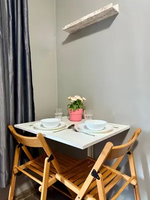 a table with two plates and a potted plant on it at Maxi studio & private parking included in Sofia