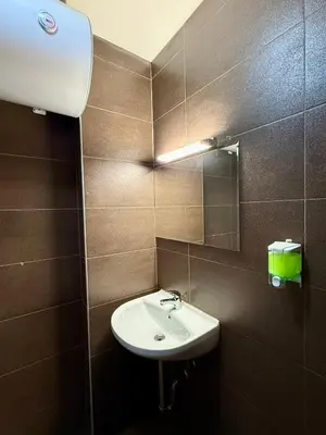 a bathroom with a sink and a mirror at Maxi studio & private parking included in Sofia