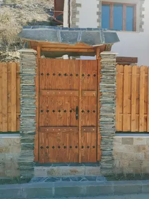 a wooden gate in front of a house at ADVENTURE apartments Trigrad in Trigrad