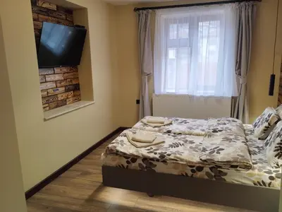 a small bedroom with a bed and a television at ADVENTURE apartments Trigrad in Trigrad
