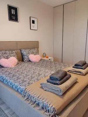 a bedroom with a bed with towels on it at Your Home in Plovdiv with Free Private Parking in Plovdiv