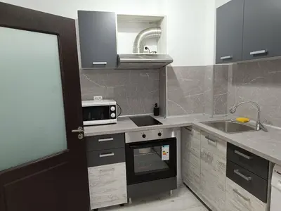 a kitchen with a stove and a sink and a microwave at One-Bedroom Apartment-14 Filip Makedonski 49B in Plovdiv