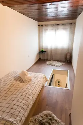 a bedroom with a bed and a room with a window at Artistic and cozy apartment in the center of Sofia in Sofia
