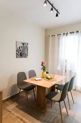 a dining room with a wooden table and chairs at Artistic and cozy apartment in the center of Sofia in Sofia