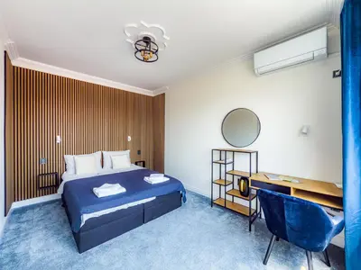 a hotel room with a bed and a desk at Kolev Apartment 1 in Sofia