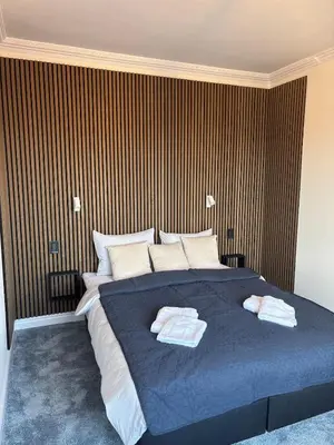 a bedroom with a large bed with two towels on it at Kolev Apartment 1 in Sofia