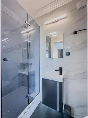 a bathroom with a glass shower and a sink at Kolev Apartment 2 in Sofia