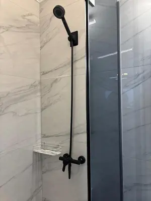 a shower with a glass door in a bathroom at Kolev Apartment 2 in Sofia