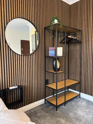 a room with a shelf in front of a mirror at Kolev Apartment 2 in Sofia