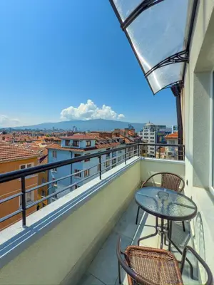 a balcony with a table and chairs and a view at Kolev Apartment 2 in Sofia