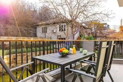 a table with a bowl of fruit on a balcony at 2 BR Apt Dzhendem Tepe 2 Parking Spots in Plovdiv next to MU in Plovdiv