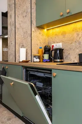 a kitchen with an open dishwasher in a counter at 2 BR Apt Dzhendem Tepe 2 Parking Spots in Plovdiv next to MU in Plovdiv