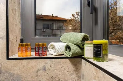 a window sill with towels and essential oils on a counter at 2 BR Apt Dzhendem Tepe 2 Parking Spots in Plovdiv next to MU in Plovdiv