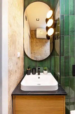 a bathroom with a sink and a mirror at 2 BR Apt Dzhendem Tepe 2 Parking Spots in Plovdiv next to MU in Plovdiv