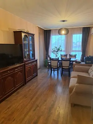 a living room with a television and a dining room at Vitosha Apartment in Sofia