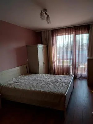 a bedroom with a bed and a large window at Vitosha Apartment in Sofia