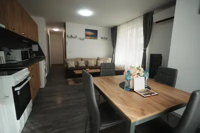 a kitchen and dining room with a table and a couch at Royal nest in Sofia