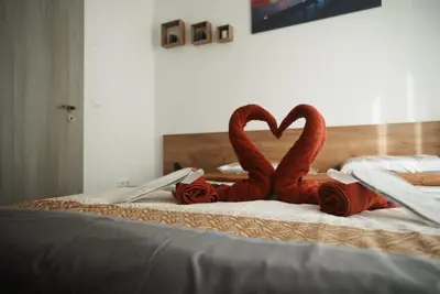 two flamingos are sitting on top of a bed at Royal nest in Sofia