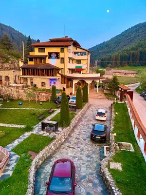 a group of cars parked in front of a building at Trigrad hills in Trigrad