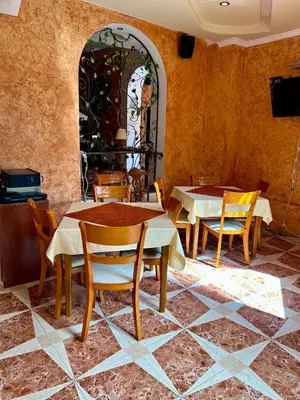a dining room with tables and chairs and a window at Trigrad hills in Trigrad