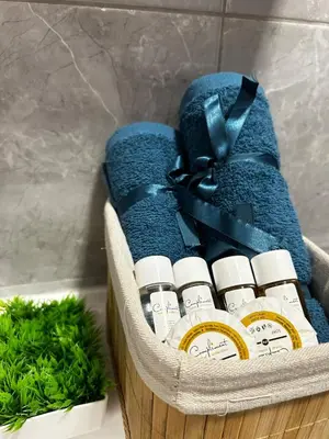 a basket filled with lots of essential oils and a plant at Rea Elita - Fresh and Modern Studio in Sofia