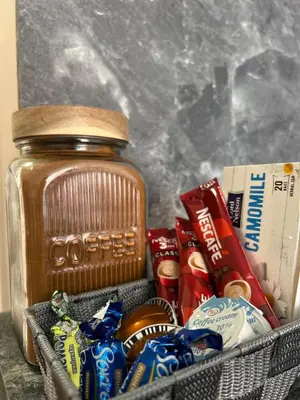 a basket with a jar of peanut butter and other snacks at Rea Elita - Fresh and Modern Studio in Sofia