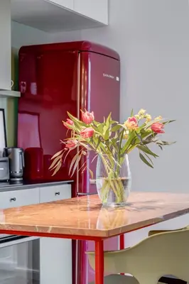 a vase of flowers sitting on a table in a kitchen at Quiet Elegance in Sofia Center in Sofia