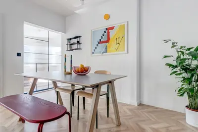 a dining room with a table and a plant at Quiet Elegance in Sofia Center in Sofia
