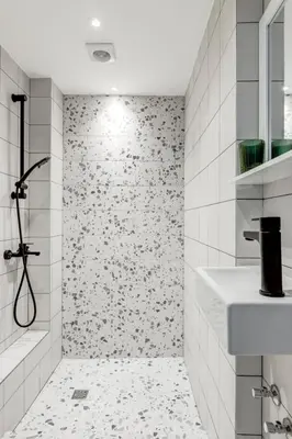 a bathroom with a shower with black and white tiles at Quiet Elegance in Sofia Center in Sofia