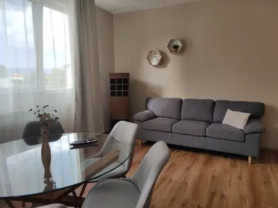 a living room with a glass table and a couch at Тристаен апартамент in Elin Pelin