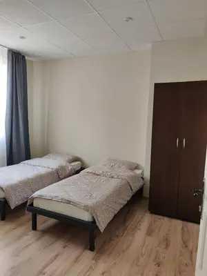 a room with two beds and a cabinet at Тристаен апартамент in Elin Pelin